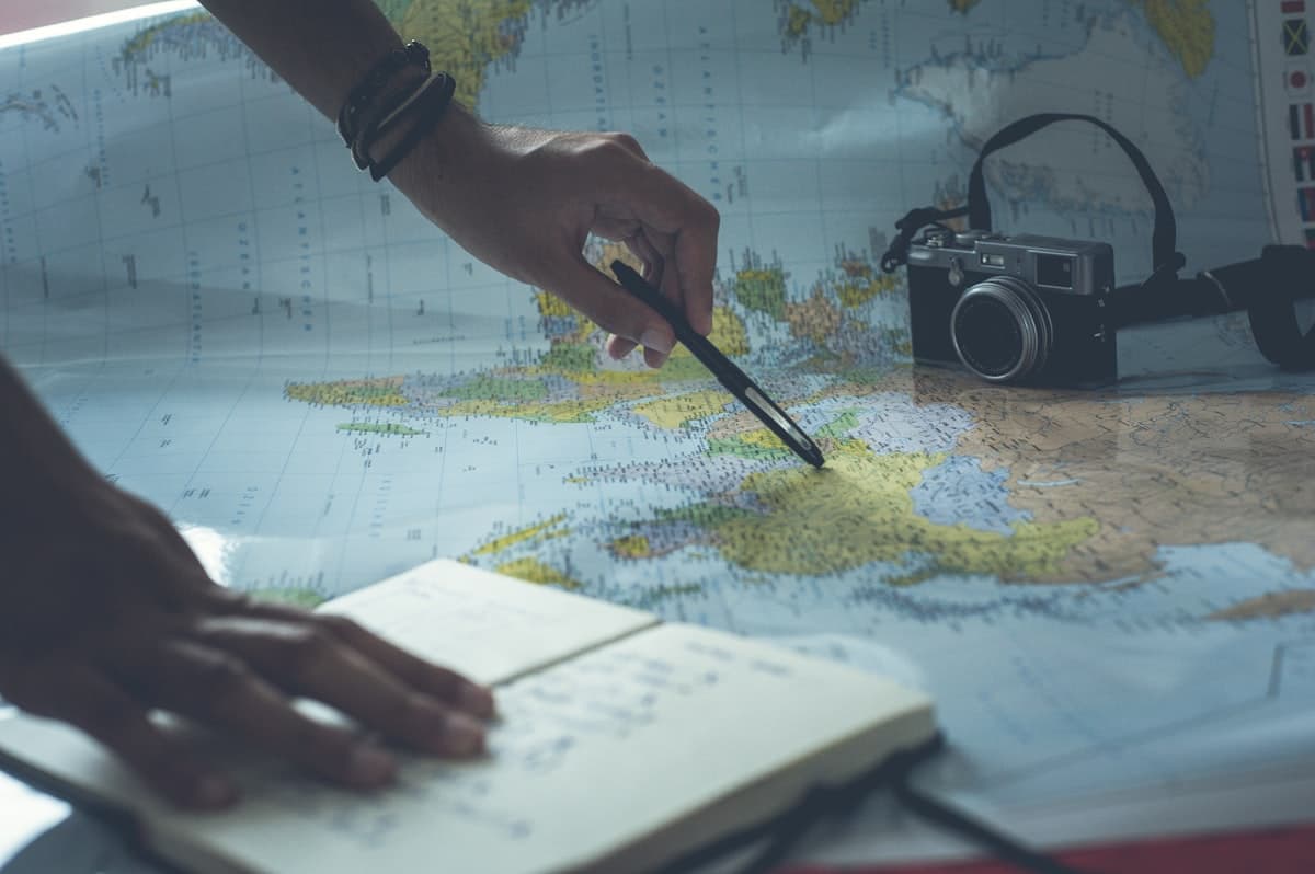Hands reviewing a map and notes, representing charting a clear financial route