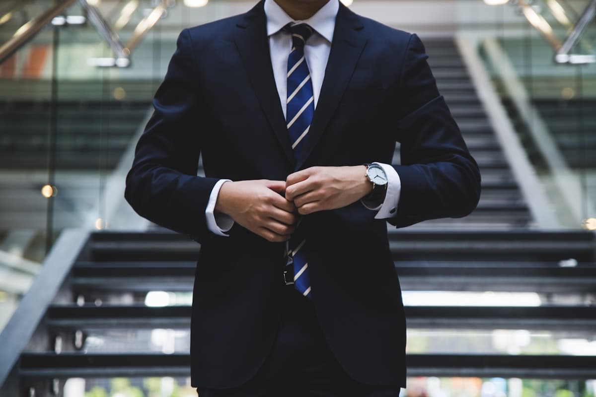 A financial professional in a navy suit, ready for a client meeting